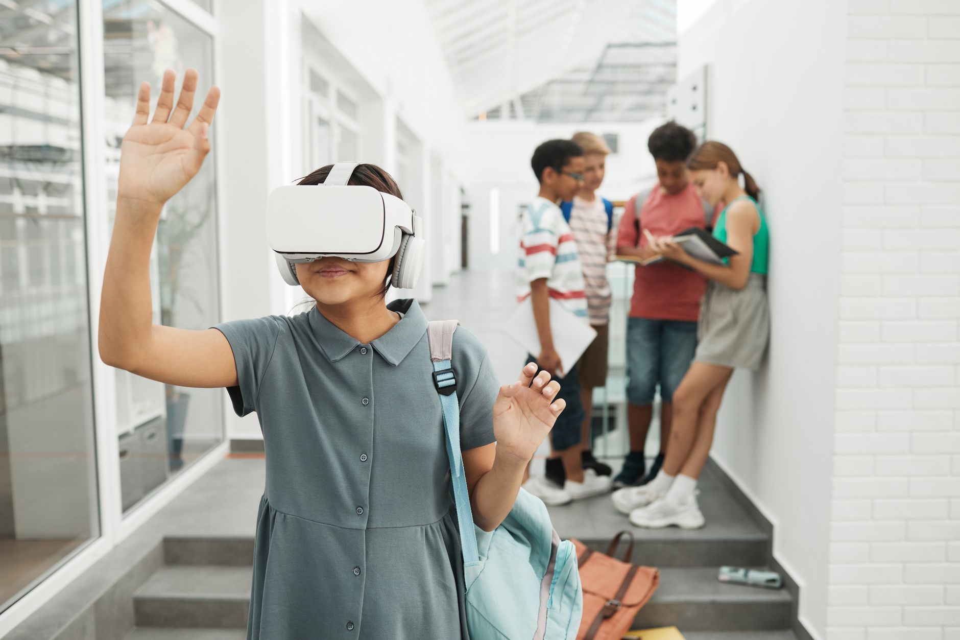Group of kids using VR in school hallway, exploring technology and learning.