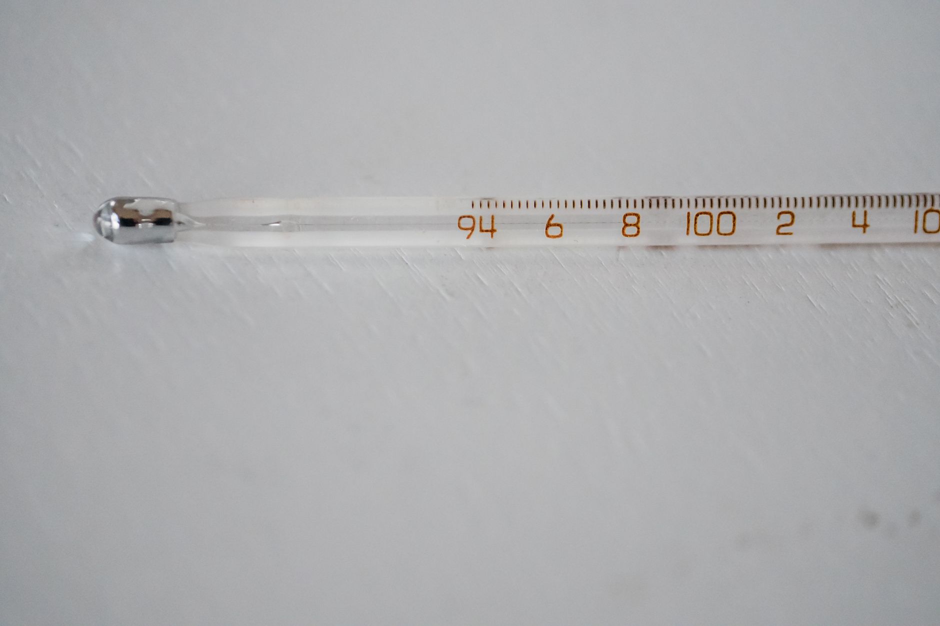 Detailed image of a glass thermometer displaying temperature in degrees.