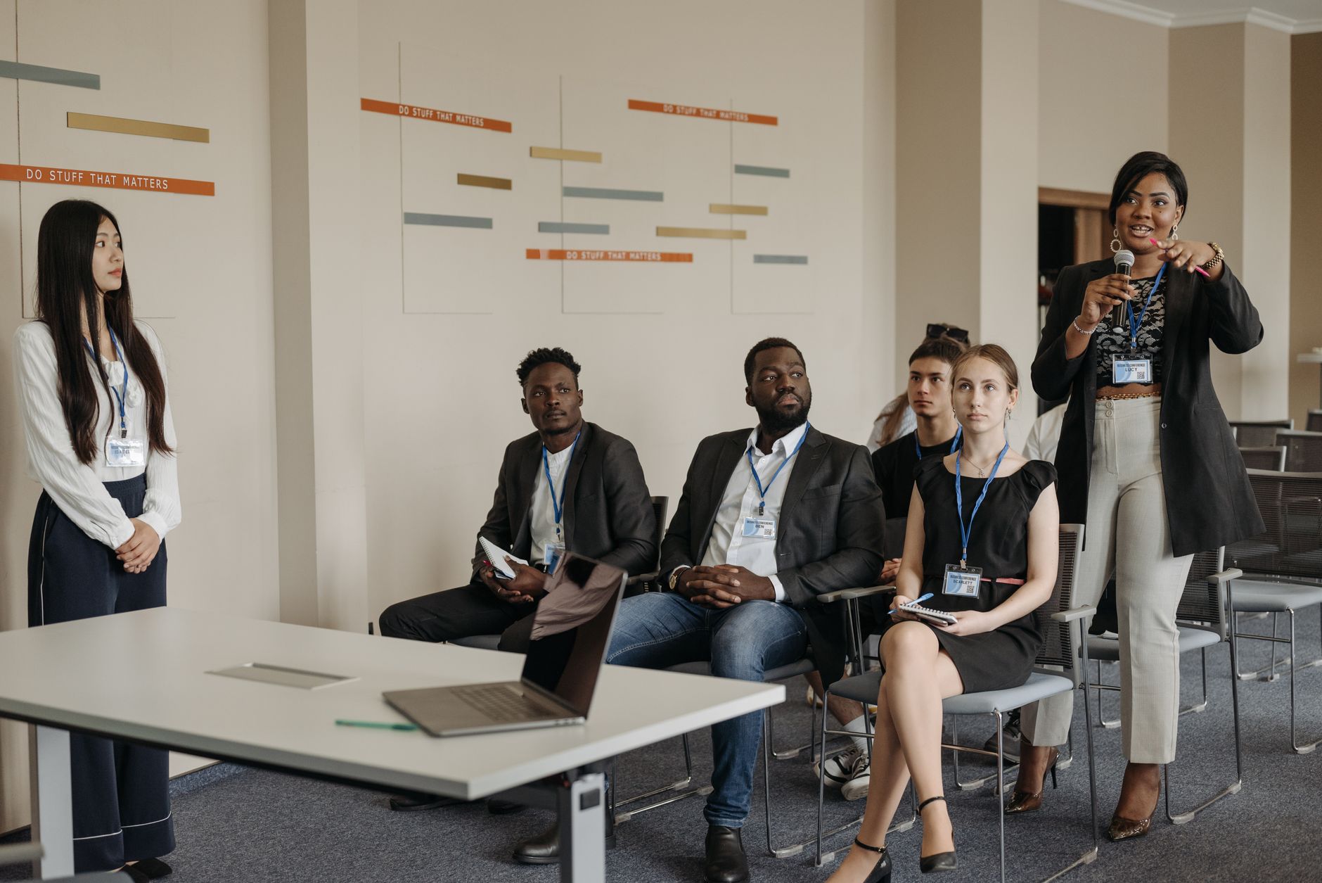 A diverse group of professionals attending a business seminar, actively participating and engaging in discussions.