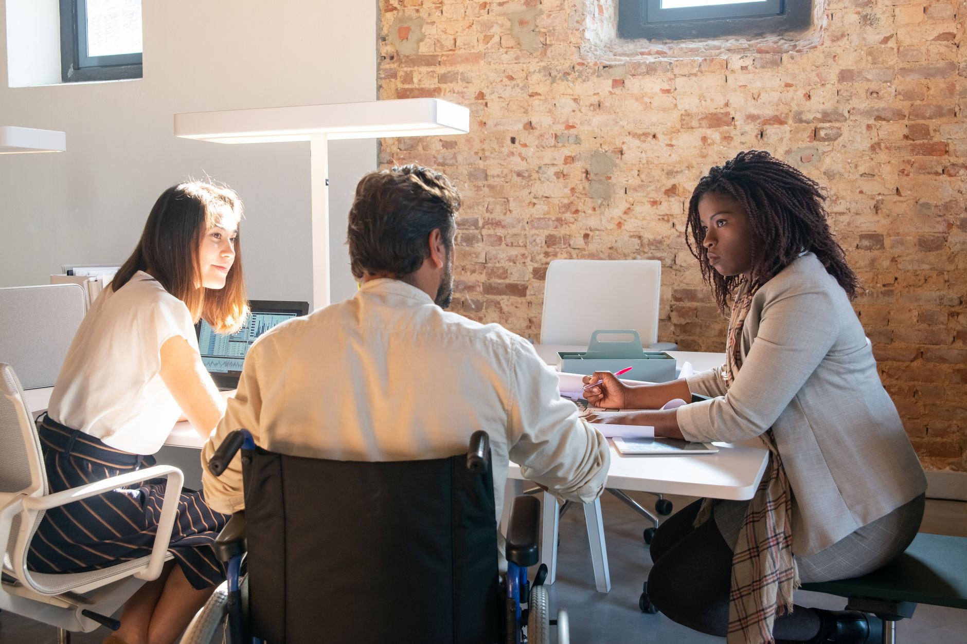 A diverse team of colleagues in a meeting, focusing on inclusive collaboration.