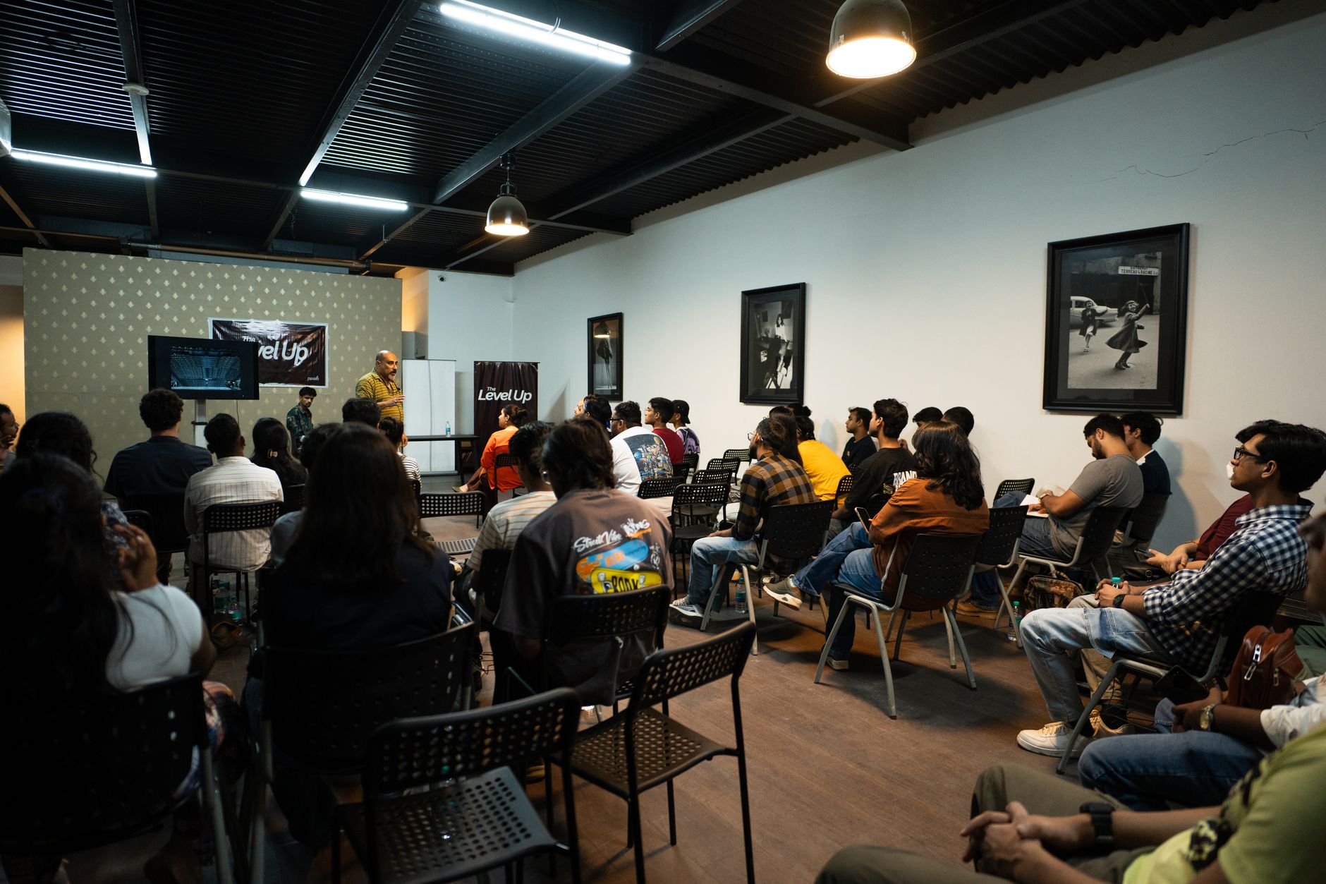 Participants attend a workshop presentation indoors with engaging visuals and discussions.